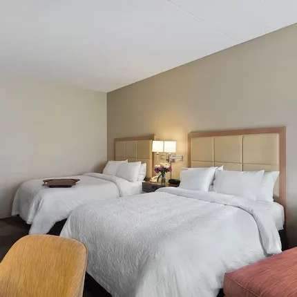 Guest room with two queen beds and seating area at Hampton Inn Scottsdale