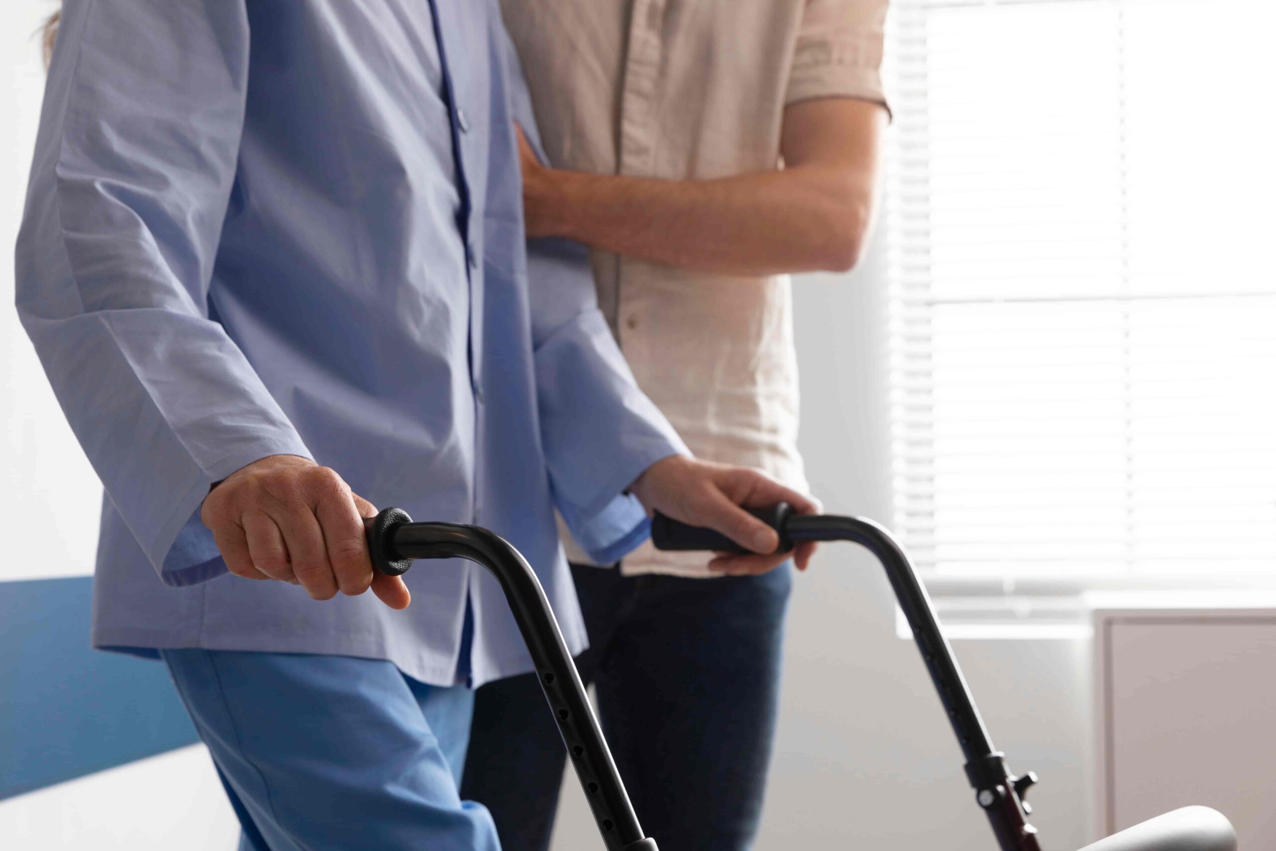 Elderly patient walking with assistance from a healthcare provider during an in-home medical visit in 85255.