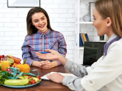 Young woman receiving lifestyle and nutrition counseling at home from a healthcare provider in Scottsdale