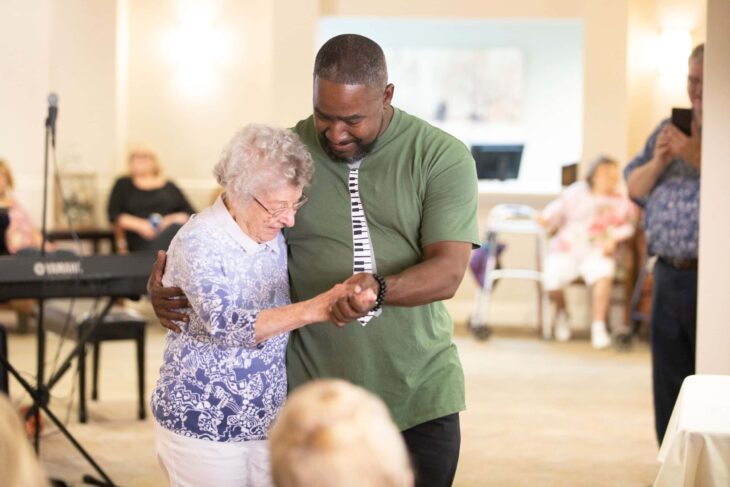 Older adult dancing with a caregiver during a wellness activity at The Ranch Estates at Scottsdale, reflecting the community’s vibrant lifestyle and compassionate care.