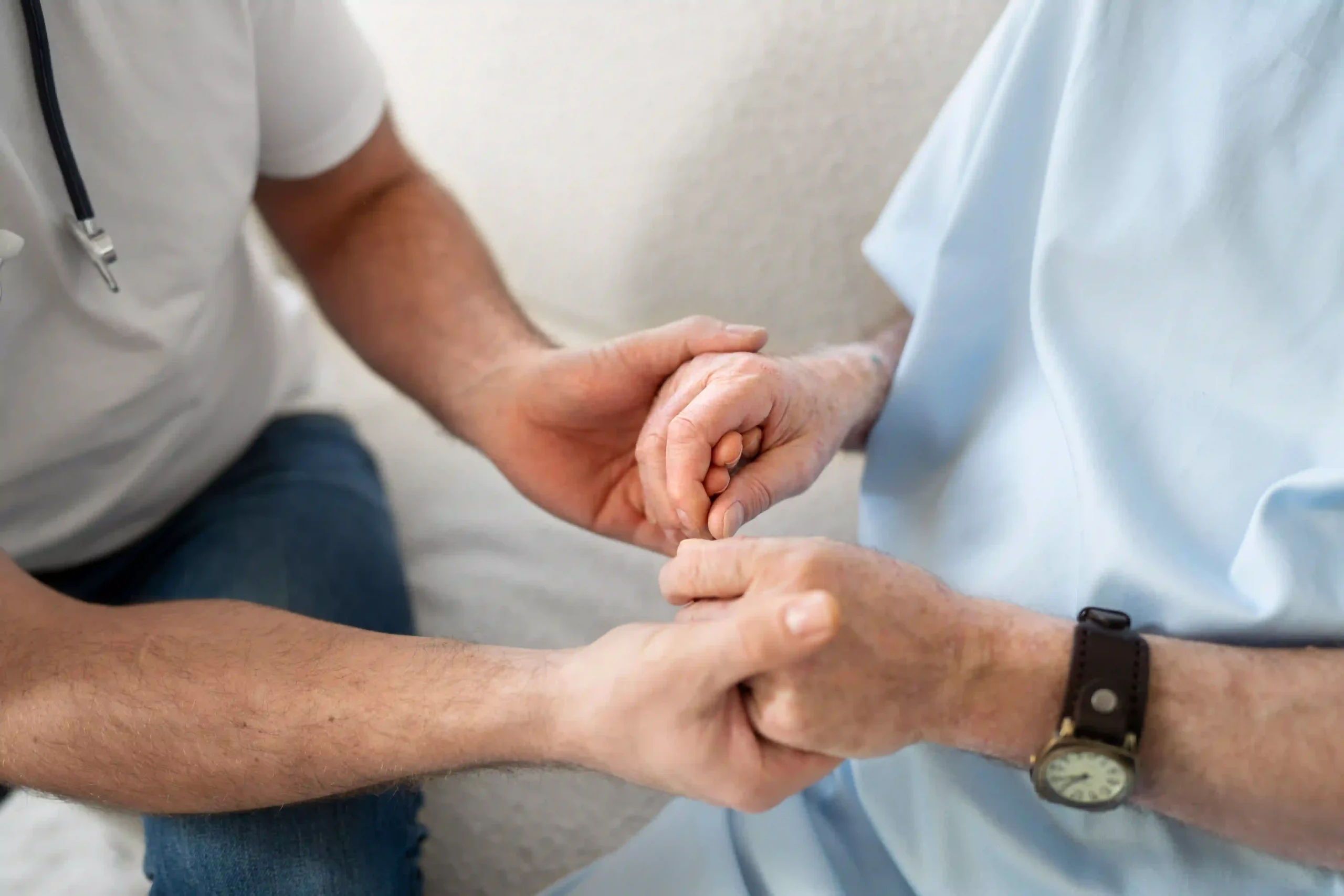 Doctor holding hands with an elderly hospice patient, offering comfort and emotional support during end-of-life care in 85262.