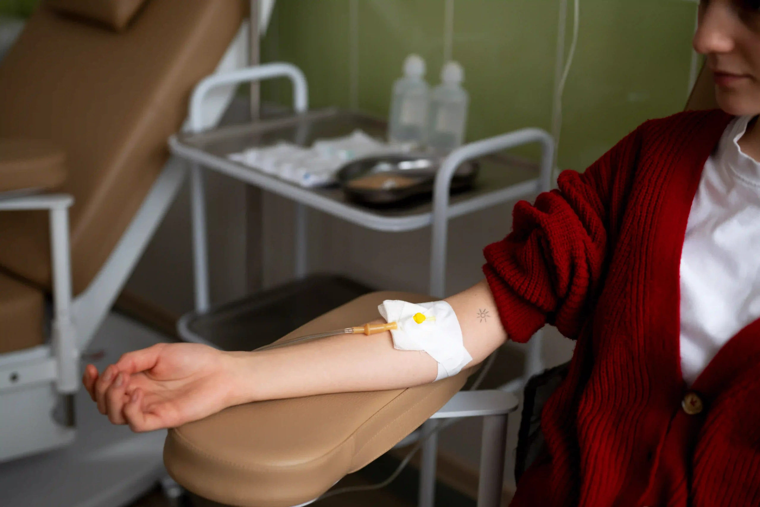 Patient receiving intravenous chemotherapy treatment in a clinical setting.