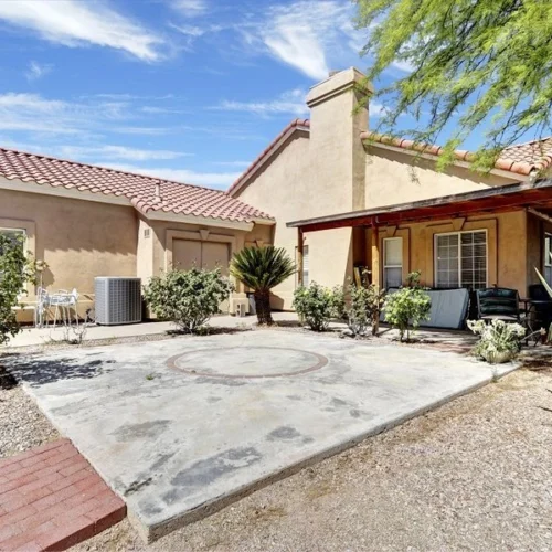Courtyard of American Dream Home II assisted living with desert landscaping and shaded patio seating