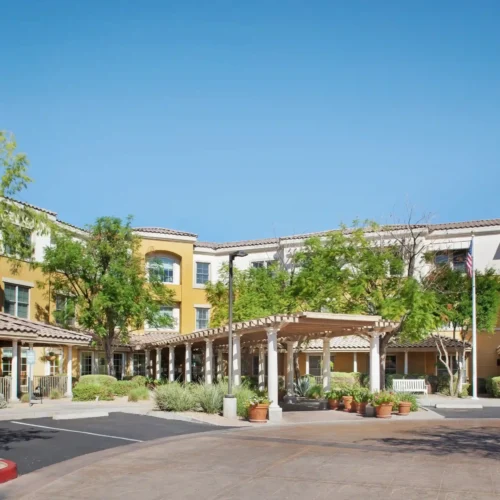 Assisted living facility exterior with landscaped entrance in Scottsdale