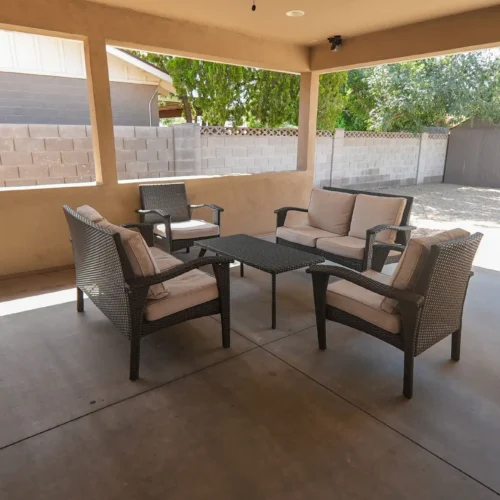 Outdoor covered patio with seating area at senior care home
