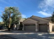 Front exterior of Assisted Living of Scottsdale II on East Shea Boulevard, Scottsdale, showing driveway, garage, and desert landscaping with palm and olive trees.