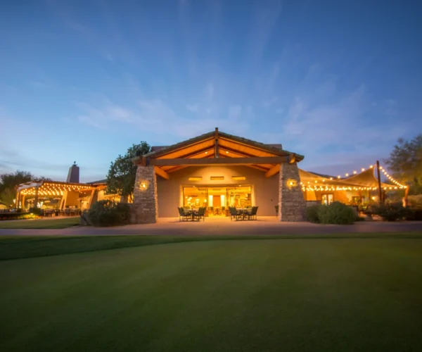 Grayhawk Golf Club clubhouse at dusk with string lights in Scottsdale, AZ. Title: Clubhouse glow at dusk.