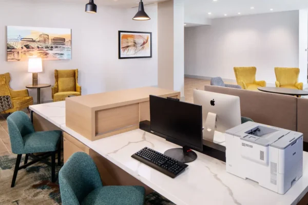 Business center and lobby workspace at Hyatt Place Scottsdale – North with computers, printer, and seating.