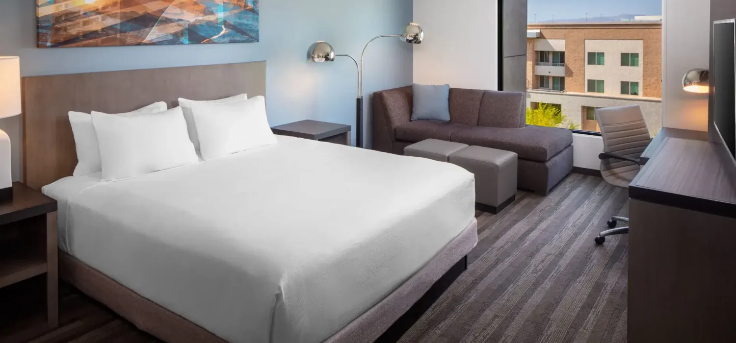 King guest room at Hyatt Place Scottsdale – North featuring a Cozy Corner sofa, work desk, and large window.