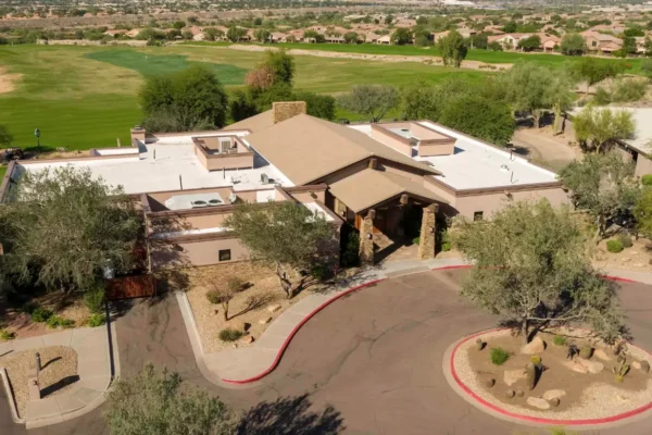 Aerial view of McDowell Mountain Golf Clubhouse with desert landscaping and surrounding golf course in Scottsdale, Arizona.