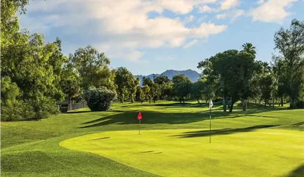 Putting green with flags and mountain backdrop at Starfire Golf Club