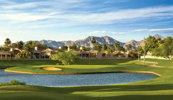 Lakeside golf hole with bunkers and mountain views at Starfire Golf Club