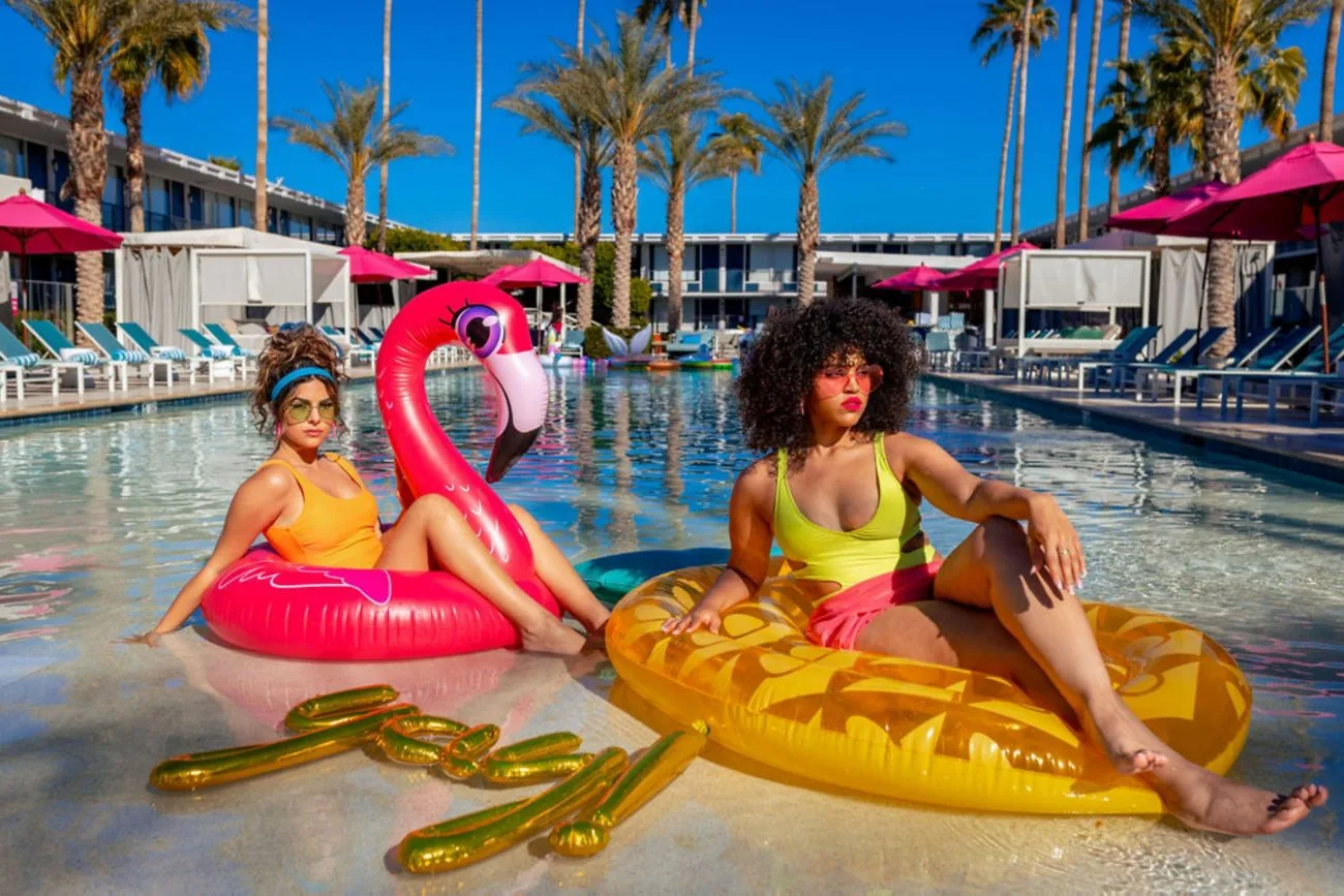 Guests relaxing on colorful floaties in the zero-edge pool at Hotel Adeline Scottsdale